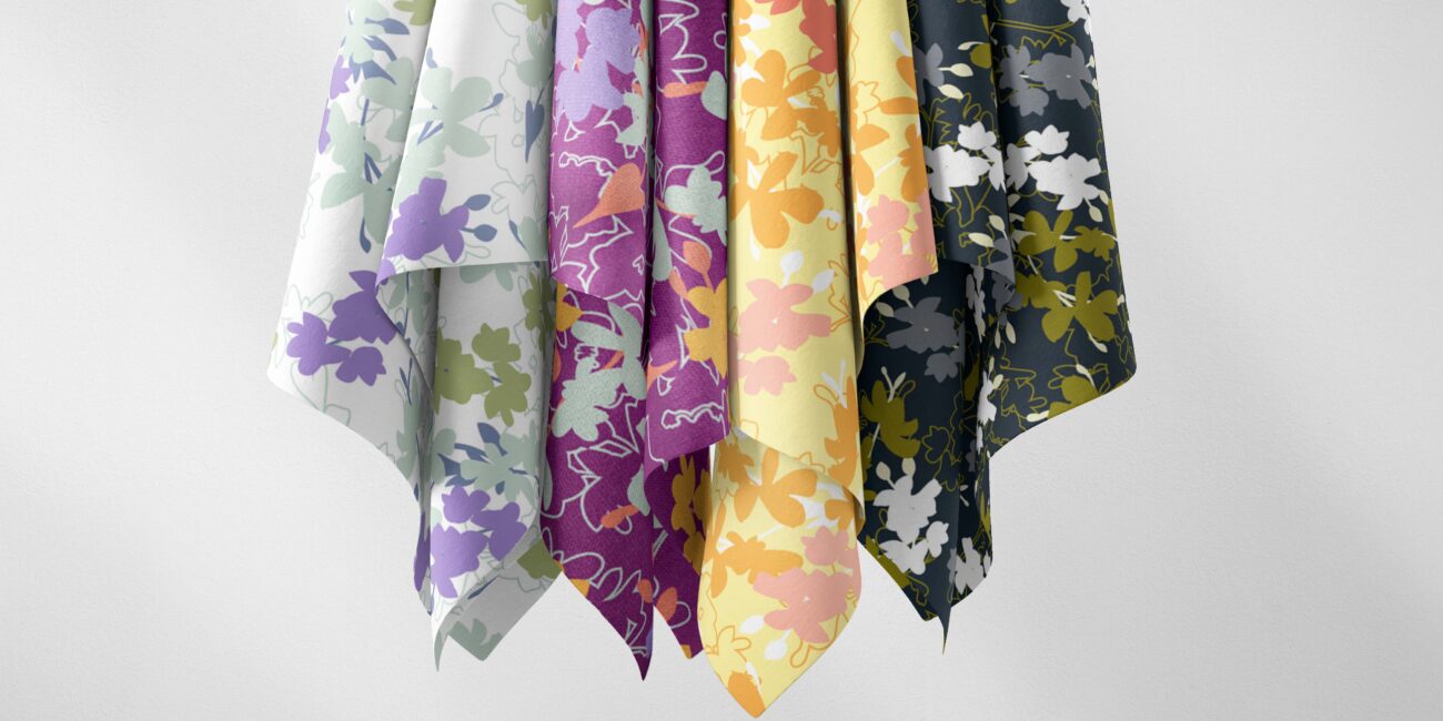 Hanging textile swatches showcasing the Eryn floral pattern in various colors: white/light green, purple, yellow/orange, and dark green/navy.